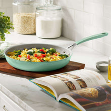 Green ceramic nonstick skillet holding colorful cooked vegetables