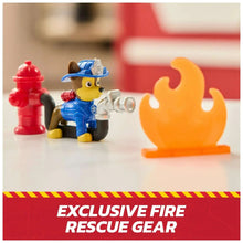 Blue-clad fire rescue dog figure with gray hose and orange flame accessory