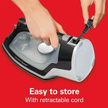 Black and silver steam iron in use with retractable cord and control dial
