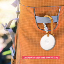 White oval item locator tag hanging from a strap on an orange bag