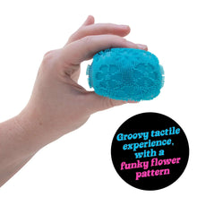 Blue fuzzy flower fidget ball held in a hand