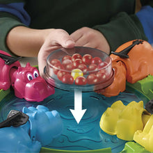 Hungry Hungry Hippos plastic hippo launcher over clear bowl of red marbles
