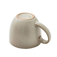 Stoneware mug, speckled cream with rounded body, rim detail, and side handle