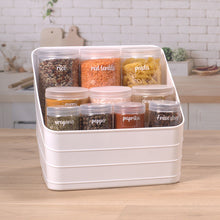 White plastic storage bin with clear lid holding spice jars
