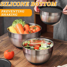 Stainless steel nesting mixing bowls with black silicone airtight lids, holding vegetables
