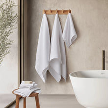 Arctic white spa towel set with three hanging towels and a folded hand towel