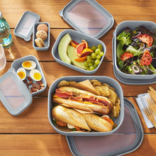 Gray rectangular food storage containers with clear-lid inserts holding food