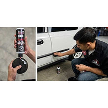 Vinyl rubber plastic protectant being applied to a car door with a foam pad