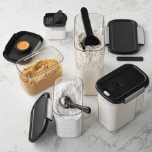 Tritan food storage set with clear bins, black lids, scoops and measuring cup