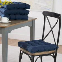 Blue tufted chair seat pad with corner ties, on chair seat