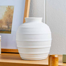 White textured ribbed ceramic vase with flared base and stacked band pattern