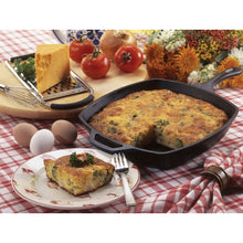 Square cast iron skillet with short handle, baked frittata and a sliced piece on plate.