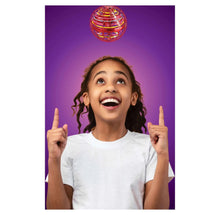Child celebrating with a floating rainbow-striped ball toy above their head