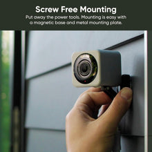 Wyze Cam V4 security camera being mounted on a wall with a hands-on lens view