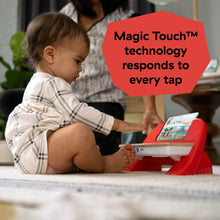 Baby using a red and white wooden piano toy with touch screen and colorful keys