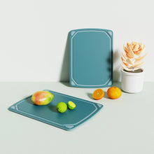 Set of two blue non-slip cutting boards on countertop