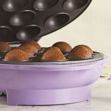 Cake pops in nonstick mold cavities on an electric cake pop maker base