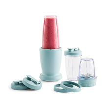 Teal blender base with red smoothie, plus teal lids and clear jar cup