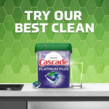 Cascade dishwasher detergent tub with green lid and matching bottle on a counter