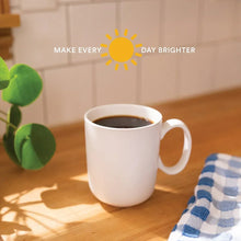 White coffee mug filled with dark brewed coffee