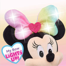 Minnie Mouse plush face with rainbow bow and sparkly glitter accents, pink outfit