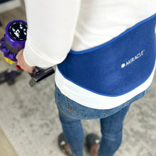 Blue back support compression wrap worn around lower back over clothing