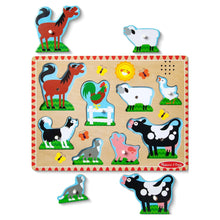 Farm animal sound puzzle board with colorful cutout pieces and raised peg slots