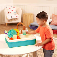 Toddler plastic sink set with brown faucet and purple soap dispenser used by child