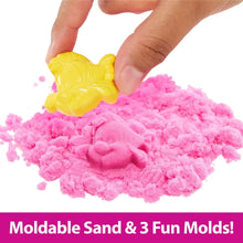 Yellow moldable sand figure pressed into pink sand