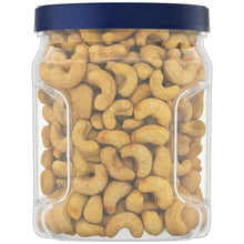 Clear cashew canister with blue lid filled with salted cashew halves and pieces