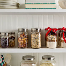Ball wide-mouth mason jars with metal lids and bands, filled with dried treats.