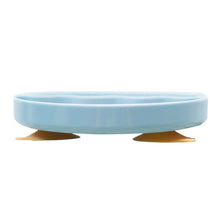 Light blue silicone suction plate with raised rim, side view