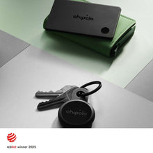 Black Bluetooth tracker card on green wallet with keys and round loop tag