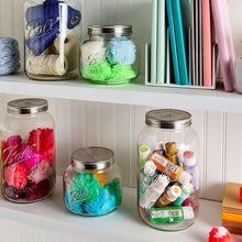 Ball mason jars with stainless lids, clear glass filled with yarn and craft supplies