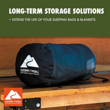 Black sleeping bag storage sack holding a blue sleeping bag, with logo patch