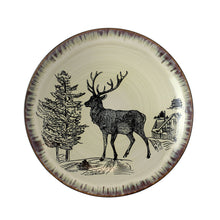 Round stoneware dinner plate with elk, pine trees, and cabin scene in taupe