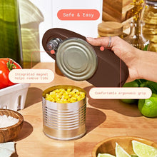 Chocolate-brown electric can opener lifts a can lid with its integrated magnet