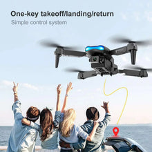 Black and gray quadcopter drone with blue LED, four rotors, front-mounted camera
