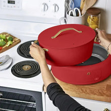 Tomato red multi-cooker with lid on, used on a countertop