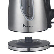 Stainless steel electric kettle close-up with front water window and base stand.
