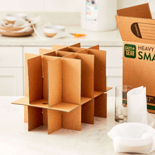 Glass packing kit with upright cardboard dividers and foam-padded glass pieces