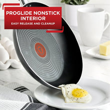 Nonstick fry pan tilted with speckled grey interior and grey handle, ready to cook