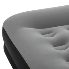 Air mattress corner close-up with gray quilted surface and dark sidewall seam detail