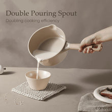 Taupe ceramic nonstick saucepan with double pouring spout, being poured