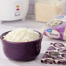 Cooked basmati rice in a purple bowl with rice bag nearby
