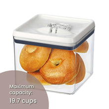 Airtight bagel food storage container with bagels inside, clear walls, white lid, dark blue band