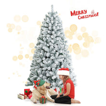 Snow flocked artificial Christmas tree with a red Santa-style hat, 6 ft