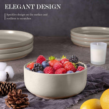 Speckled ceramic dinnerware set with a shallow bowl and stacked plates