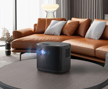 RCA home theater projector on tabletop, black vented body with front lens