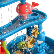 Kids dinosaur sand and water table close-up of red dolphin and flowing water jets